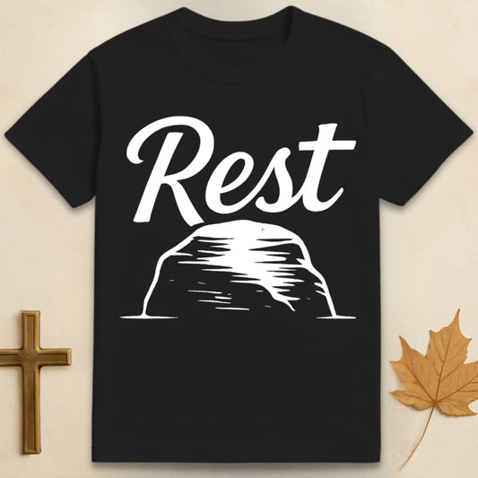 Black Rest in God t-shirt with “rest” text above  a simple rock illustration