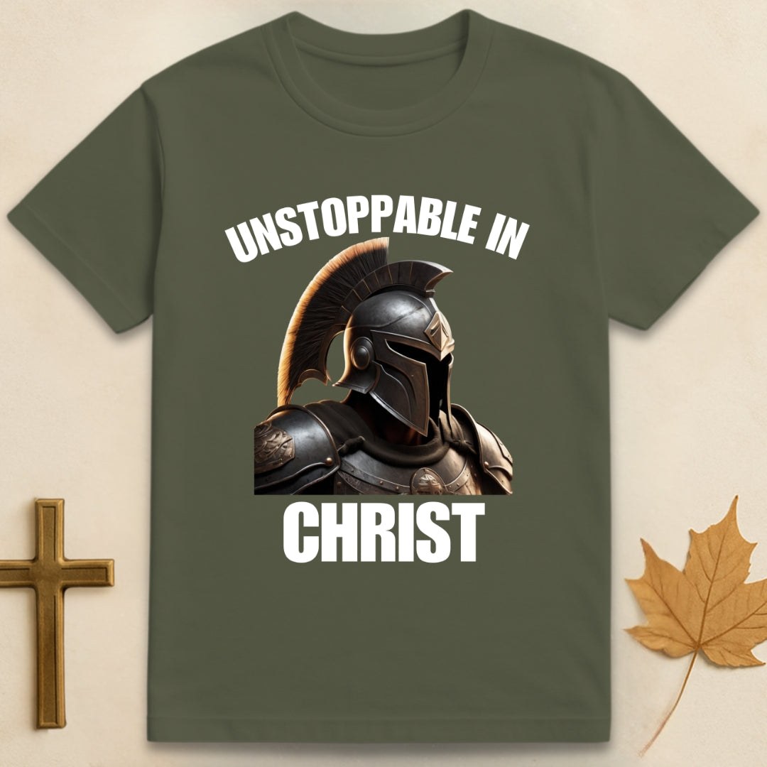 Military green Unstoppable In Christ t-shirt featuring Spartan-style helmet graphic with text "Unstoppable In" above and "Christ" below.