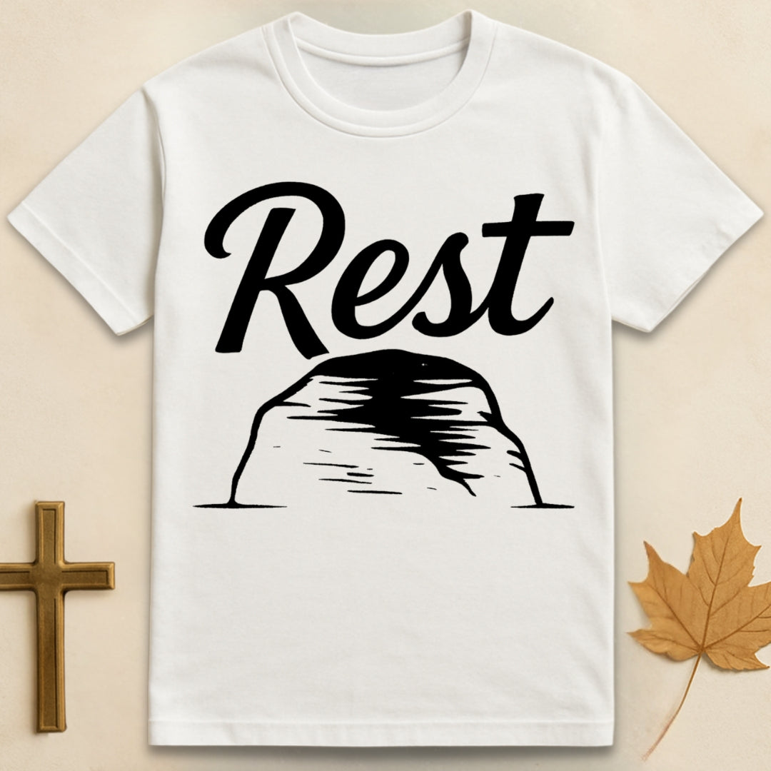 White rest in God t-shirt with “rest” text above a simple rock illustration